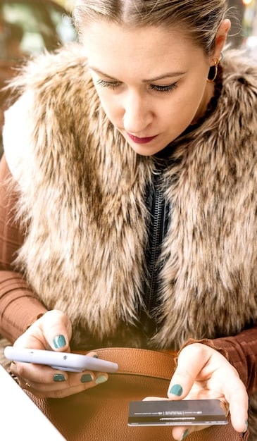 A close-up shot of a person using a budgeting app on their smartphone, with categories like 