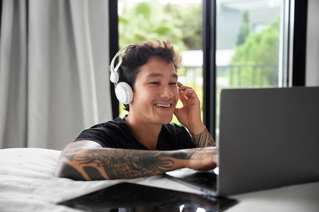 A person working on a laptop at home, with a headset on, participating in a virtual meeting and showcasing a productive and organized workspace.