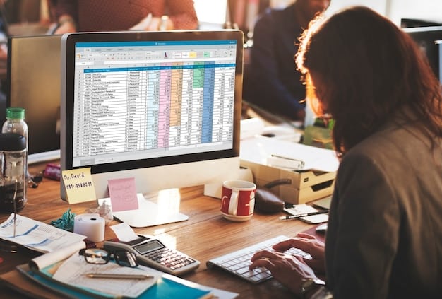 An organized spreadsheet on a computer screen, with columns for income, expenses, and net profit. A person's hands are typing data into the spreadsheet, representing meticulous record-keeping.