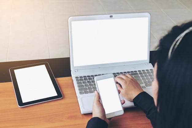 A person sitting at a desk with two laptops and a smartphone, each displaying different gig economy platform interfaces, working diligently with a focused expression. The setting is a comfortable home office.