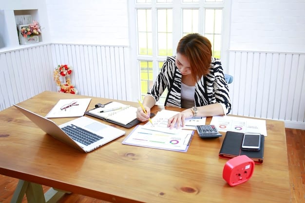 A person using a calculator while reviewing tax forms and financial documents. The setting is a well-organized home office.