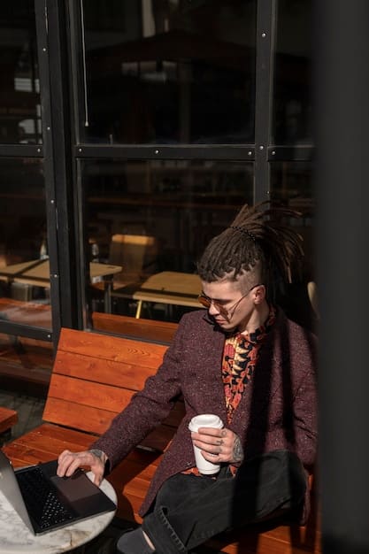 A person using a laptop at a cafe, participating in an online networking event. The scene depicts a modern, digital approach to connecting with other gig workers in a relaxed setting.