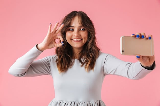 A person happily holding a product and taking a selfie for social media, with a branded background visible.