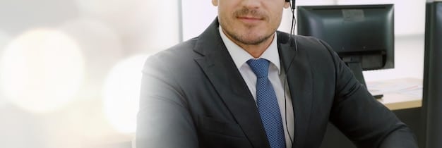 A close-up shot of a financial advisor in a suit, sitting across a desk and shaking hands with a client. The atmosphere is professional and trustworthy, emphasizing the human element of financial advising.